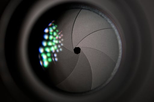 Detailed image of a camera lens aperture showing mechanical blades.